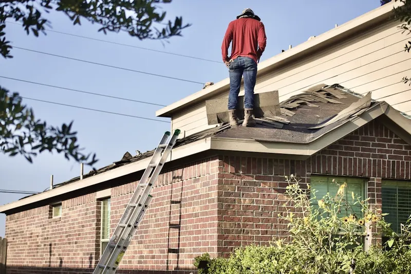 Professional roofer working on a residential roof in Strickersville